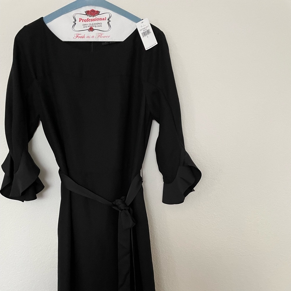 Brand new with tags never worn size 2 black dress mid calf dress with sleeves